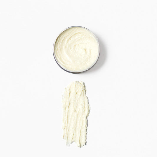 Opened 2 ounce tin of the soothing balm with a swatch on a white background