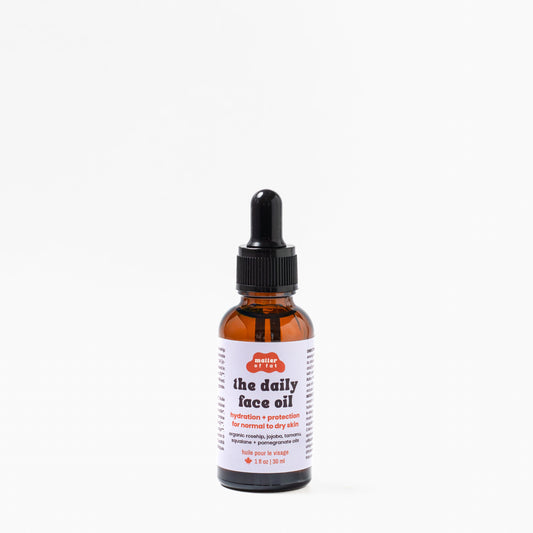 1 ounce glass dropper bottle of 'the daily face oil' on a white background