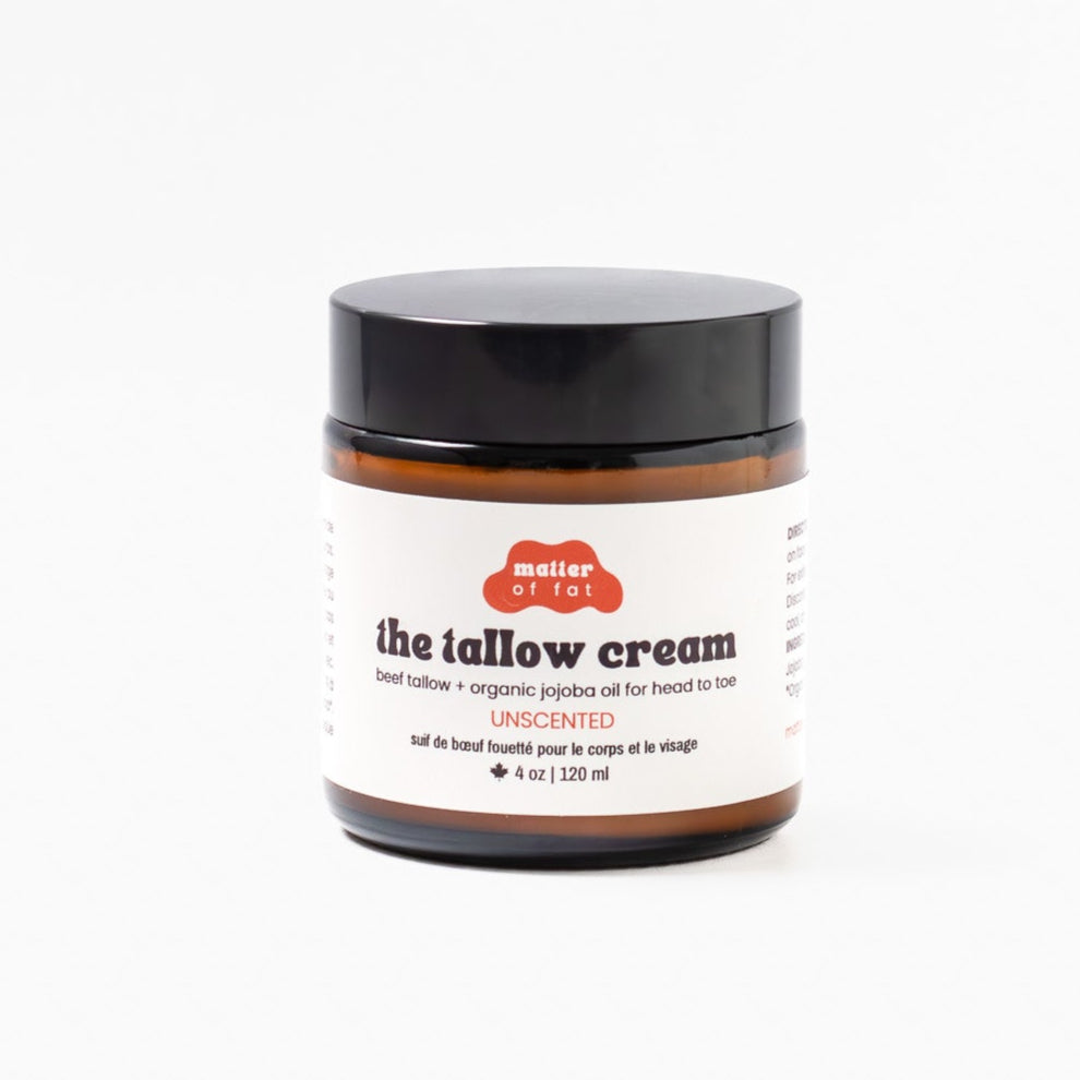 4 ounce amber jar of the tallow cream unscented with a black lid on a white background