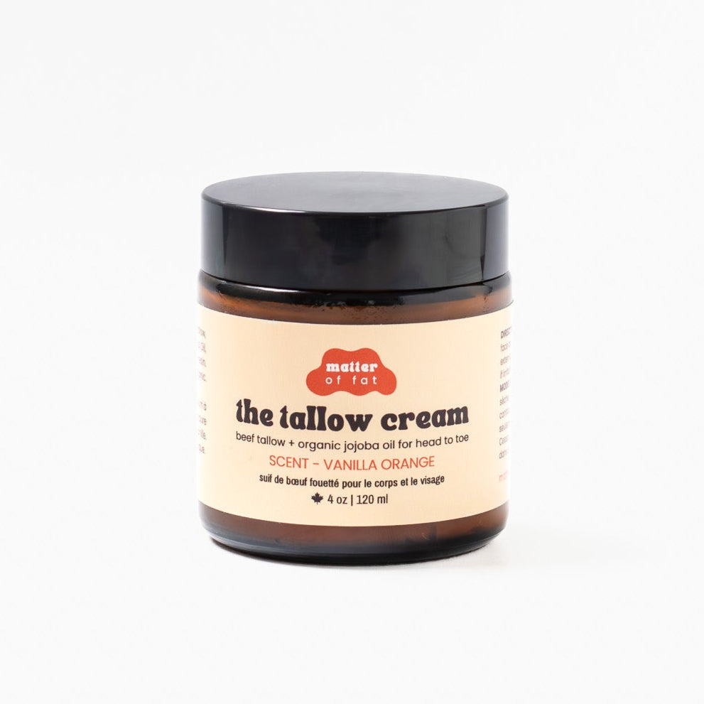 4 ounce amber jar of the tallow cream scent Vanilla Orange with a black lid on a white background